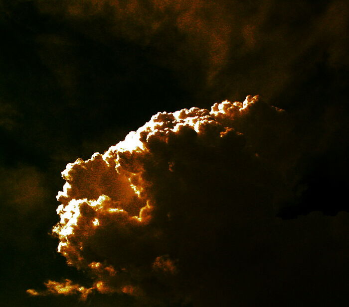Dark cloud illuminated by sunlight, showcasing the bizarre and interesting aspects of real life moments.