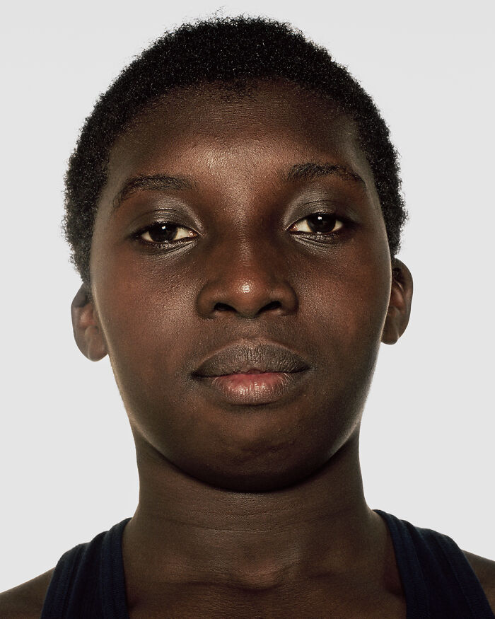 Close-up portrait of a young boxer before their first match, showcasing determination and strength in powerful photographs.