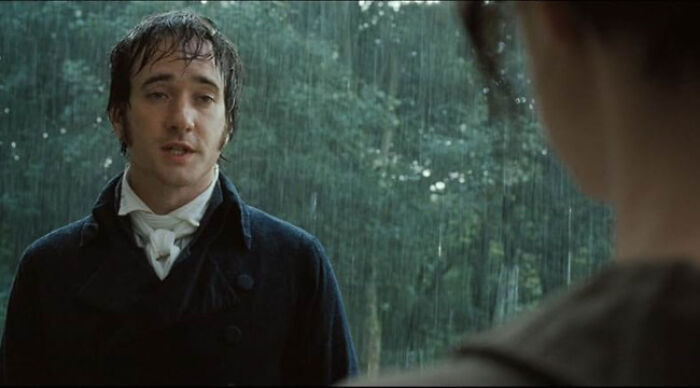 Man in period costume standing in the rain, representing beloved movie tropes in a dramatic scene.