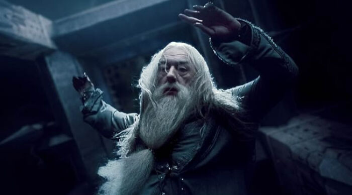 Old wizard with long white hair and beard in dark medieval clothing illustrating beloved movie tropes in fantasy films.