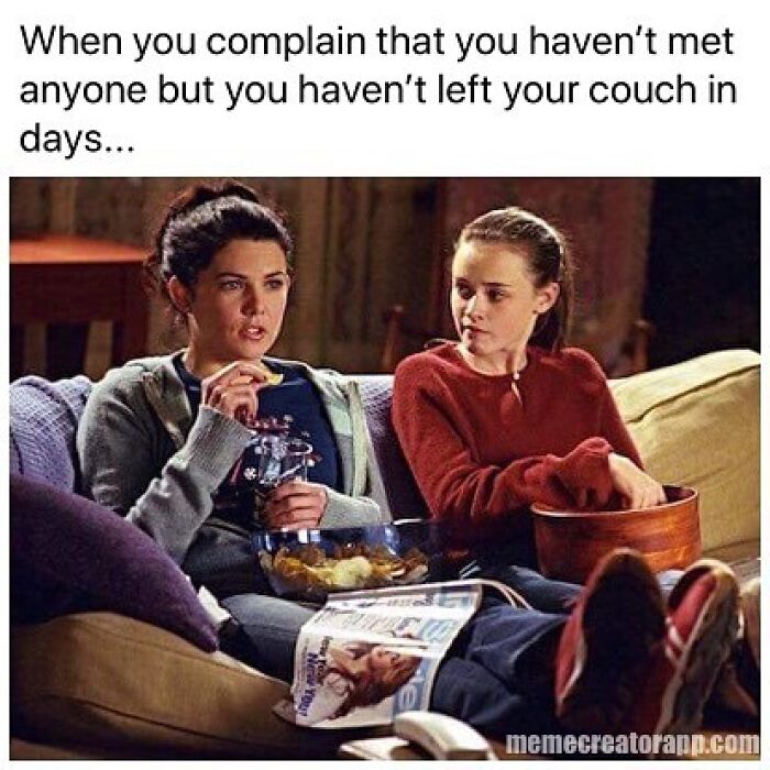 Two women sitting on a couch eating snacks, caption about complaining about not meeting anyone while staying home, dating meme.