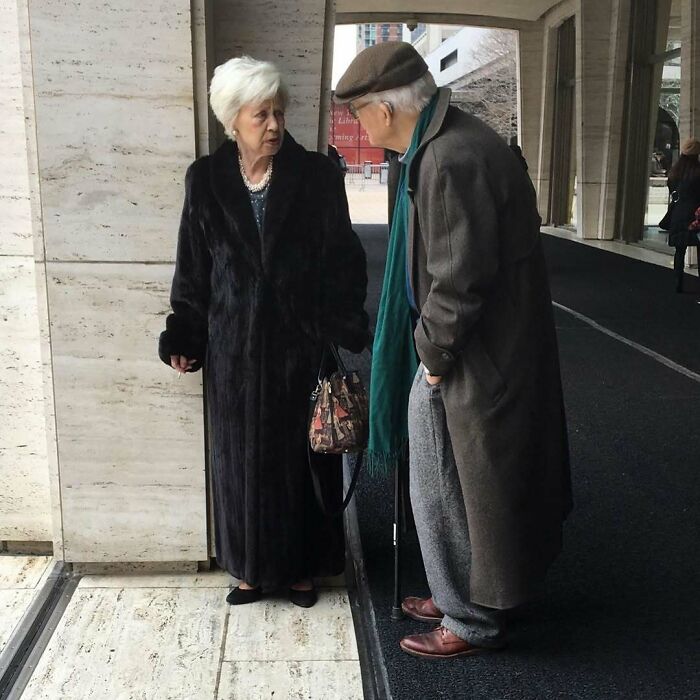Elegant grandparents dressed in stylish coats and accessories, showcasing timeless fashion that rivals younger generations.