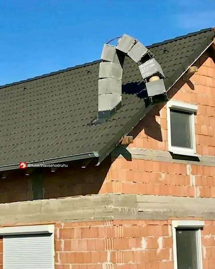 Unusual construction design with a bent brick chimney on a house roof showcasing a poorly executed building feature.