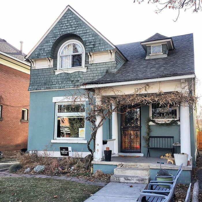 Charming old home with blue exterior, porch, and vintage details, perfect for anyone seeking adorable and lovely old homes.