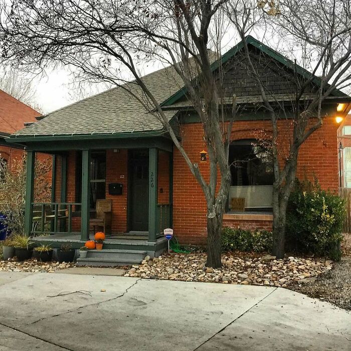 Charming old home with brick exterior, front porch, and seasonal pumpkins, perfect among adorable and lovely old homes to move into.