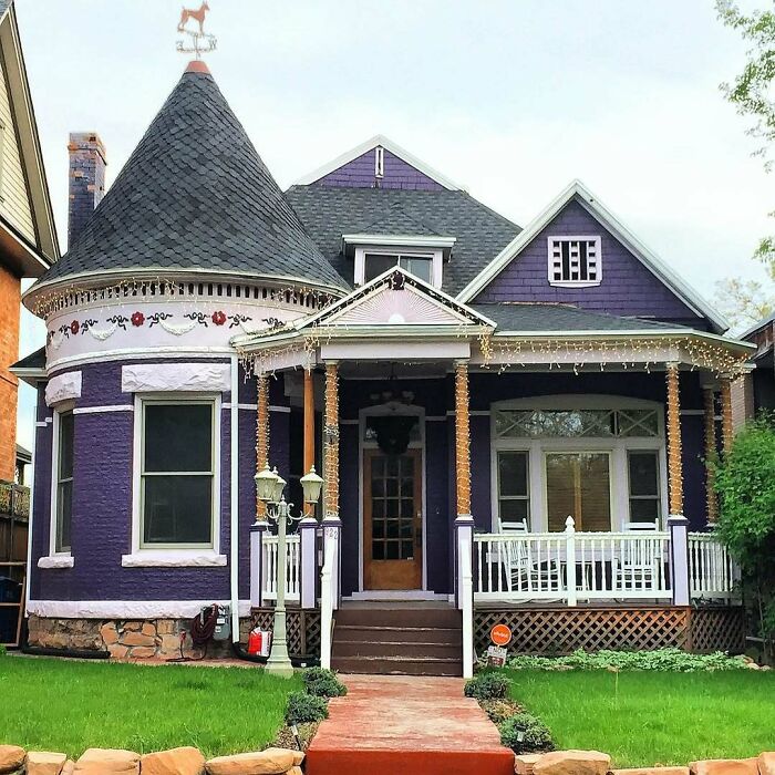 Charming purple old home with turret, porch, and decorative trim, showcasing adorable and lovely old homes for move-in inspiration.