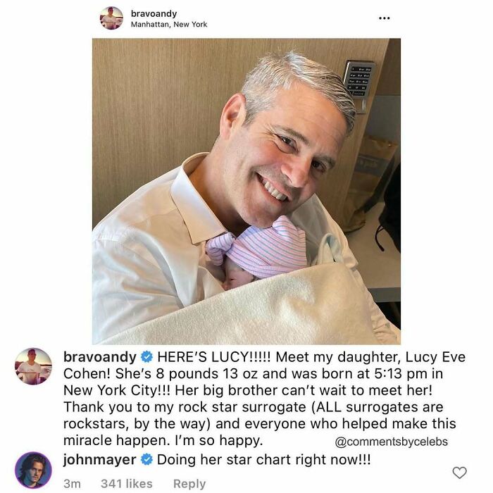 Andy Cohen holding his newborn daughter with a celeb comment dropping an unexpected gem in the comments section.