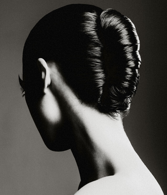 Black-and-white photo of a person’s back and head with sleek hair, showcasing award-winning Exposure One photography.