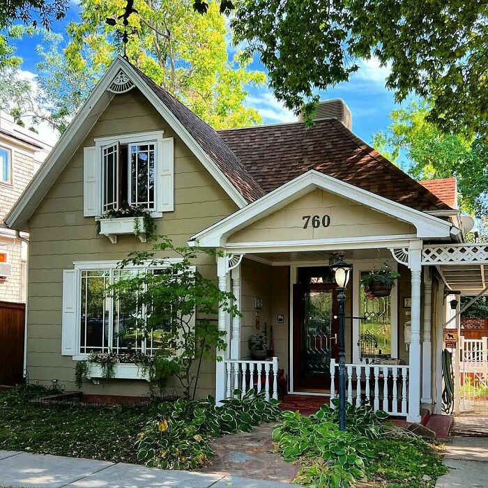 Charming old home with classic architecture, greenery, and a cozy porch, perfect for those seeking adorable and lovely old homes.