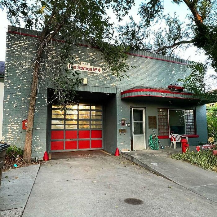 Old charming home with red accents and greenery, showcasing the appeal of adorable and lovely old homes to move into.