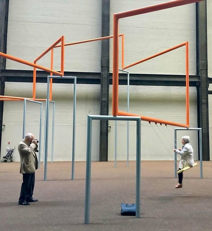 Elderly couple enjoying a modern playground, showcasing stylish grandparents with outfits that defy their age.