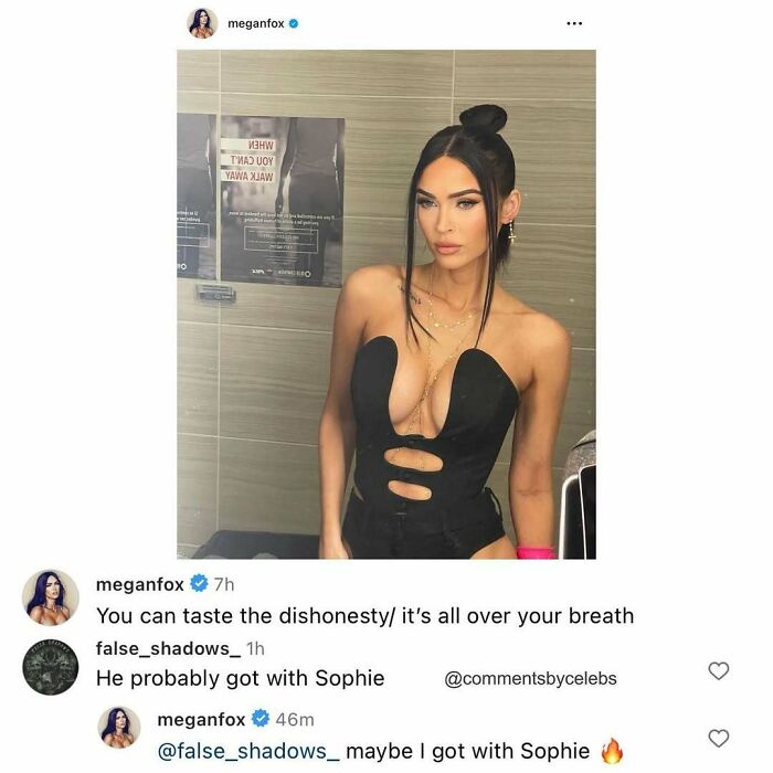 Megan Fox wearing a black cutout dress posing in a bathroom with celebrity unexpected gems in comments.