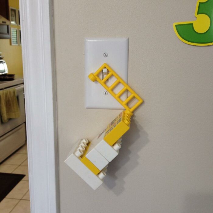 Child’s inventive LEGO creation acting as a light switch extender, showcasing kids’ surprising new inventions.