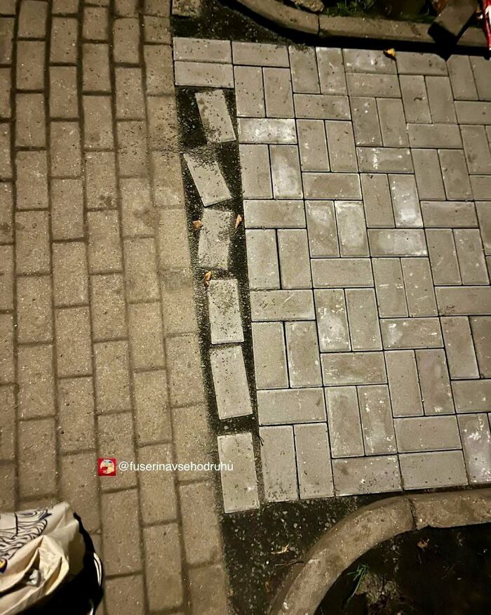 Uneven paving construction and design with misaligned bricks creating a flawed and confusing pattern on the ground.