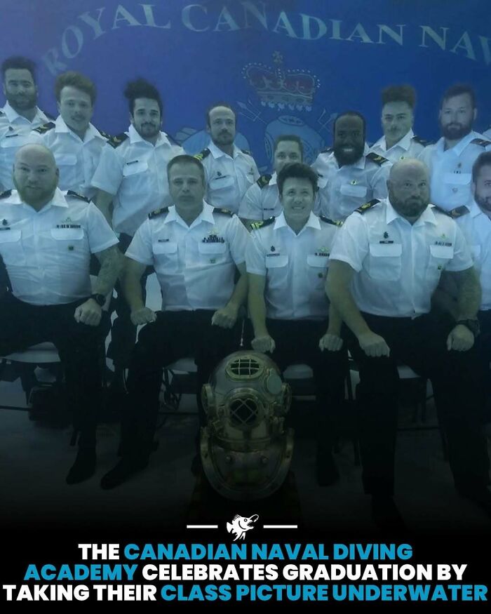 Canadian Naval Diving Academy graduates in uniform posing underwater with a vintage deep sea diving helmet in front.