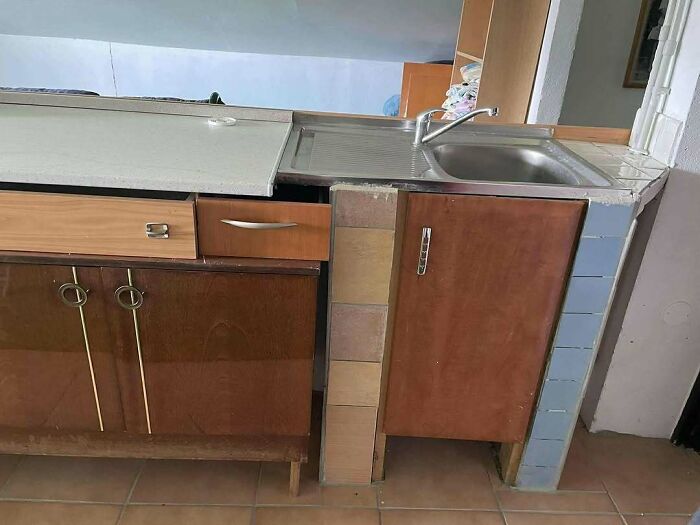 Kitchen construction fails with mismatched cabinets, uneven tiles, and poor design in bizarre construction and designs.