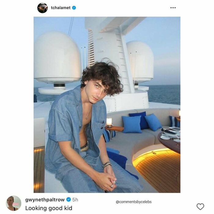 Timothée Chalamet sitting on a yacht deck wearing a denim shirt and jeans with relaxed expression, celeb comment highlight.
