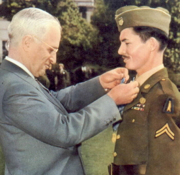 President Truman awarding a military medal, symbolizing bold decisions that made a massive impact worldwide.