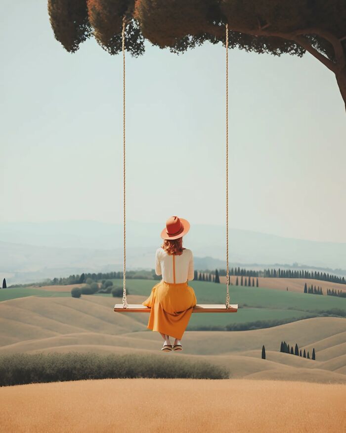 Woman in a yellow skirt sitting on a swing overlooking peaceful minimalist landscape and rolling hills.