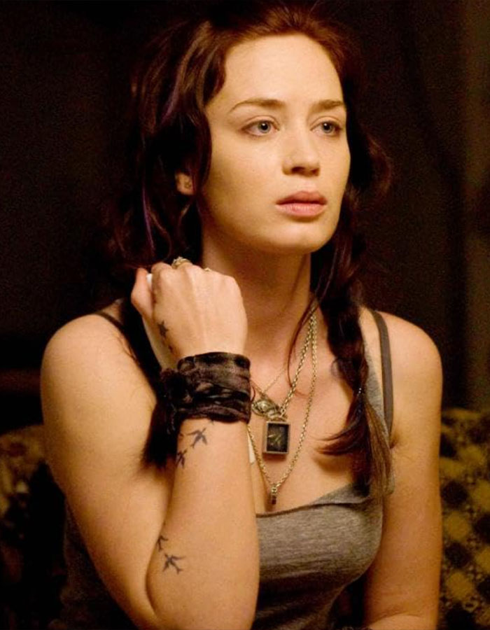 Emily Blunt in a sleeveless top with braided hair, sparking plastic surgery rumors with her natural look.