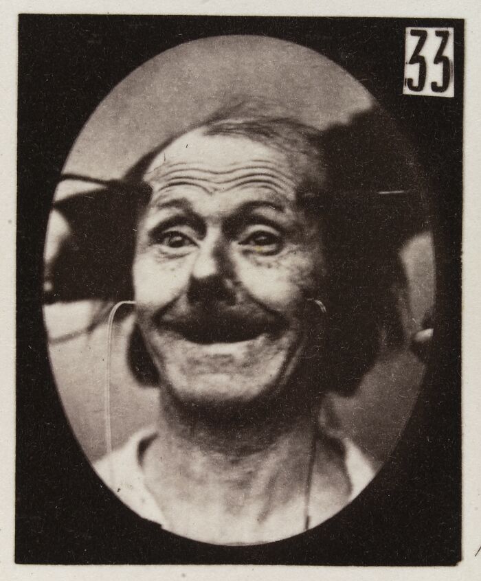 Black and white 19th century facial expressions experiment photo showing a distorted, unsettling old man's face.