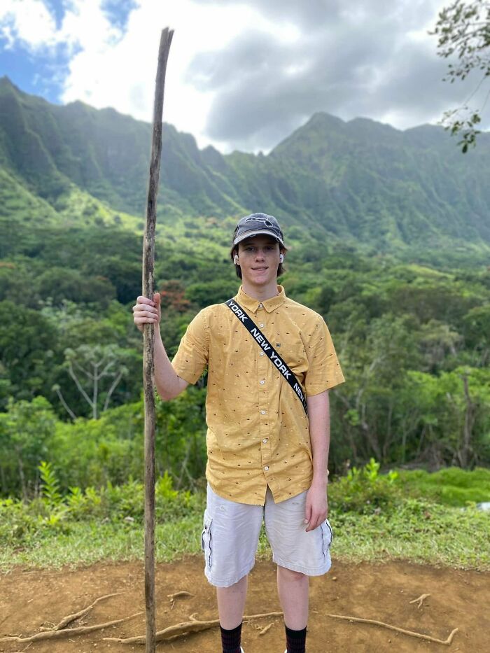 Young man holding a stick outdoors with mountains in the background, related to Charlie Kirk assassin&rsquo;s roommate story.