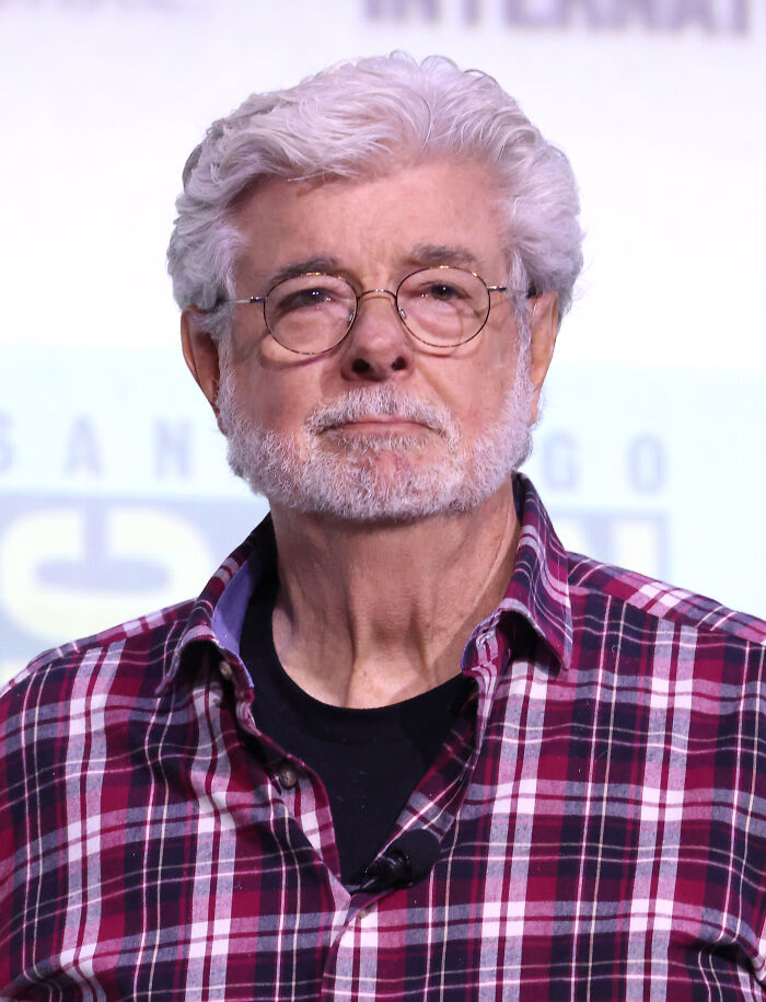 Older man with white hair and glasses wearing a red plaid shirt, representing real-life stories of people becoming what they once hated.