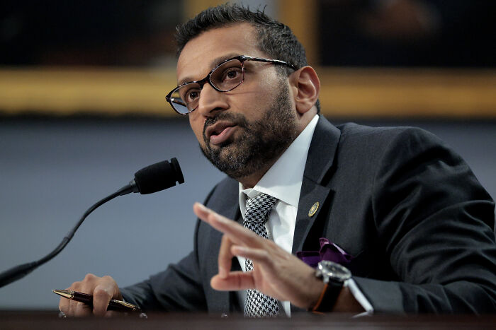 FBI Director speaking into a microphone during a formal hearing amid calls to quit over Charlie Kirk case mistake.