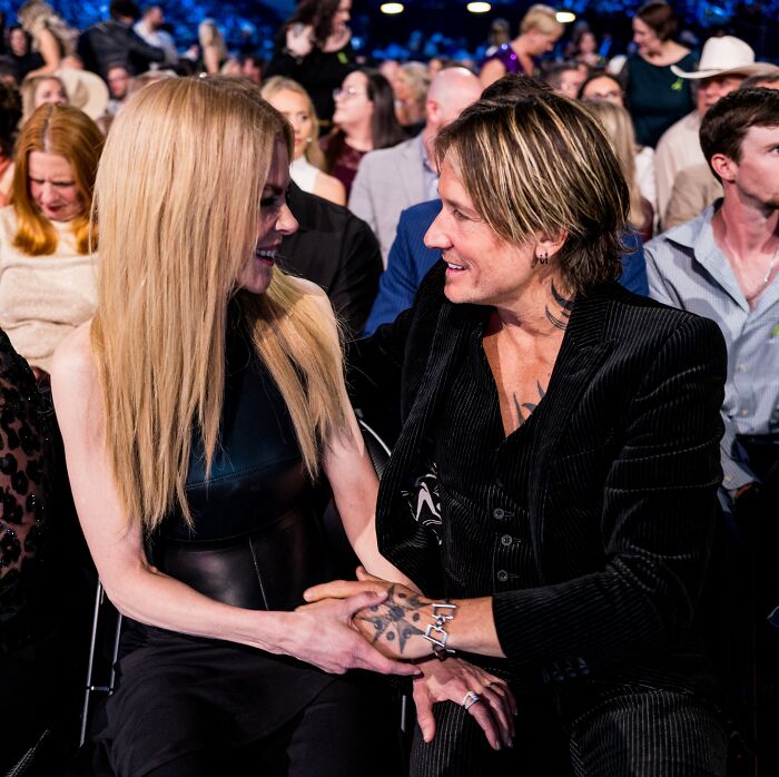 Nicole Kidman and Keith Urban holding hands and smiling at a crowded event amid split reactions and Jimmy Fallon talks