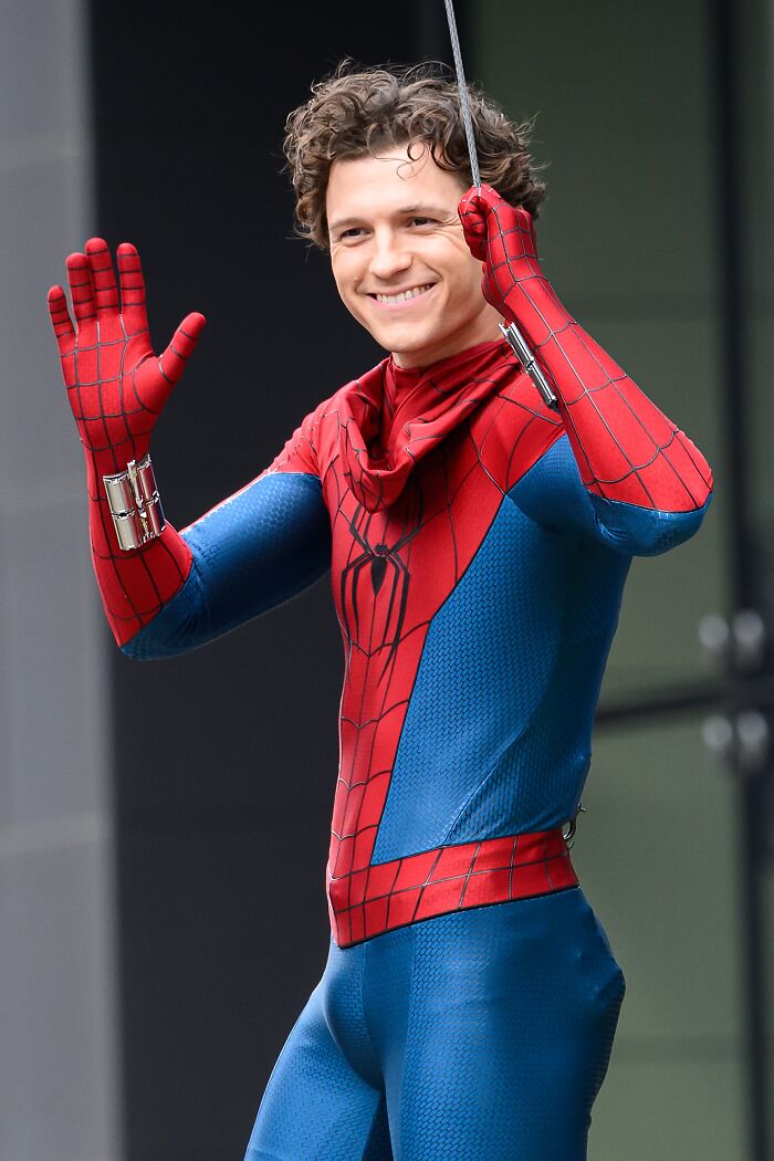 Tom Holland in Spider-Man costume performing stunt with safety harness amid head injury hospital rush news. Tom Holland in Spider-Man costume performing stunt with safety harness amid head injury hospital rush news.