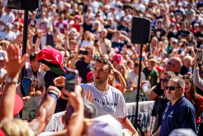 Crowd at a political rally with Charlie Kirk engaging attendees, related to Charlie Kirk assassin&rsquo;s roommate issues revealed by family.
