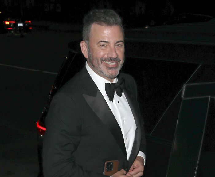 Jimmy Kimmel in a black tuxedo smiling outside at night, related to staff threat of mutiny before return. Jimmy Kimmel in a black tuxedo smiling outside at night, related to staff threat of mutiny before return.