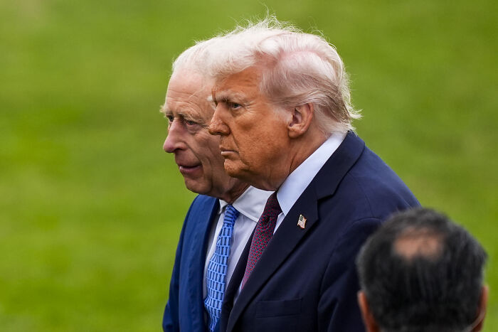 King Charles and Donald Trump walking side by side, showing subtle signs of impatience during state visit.