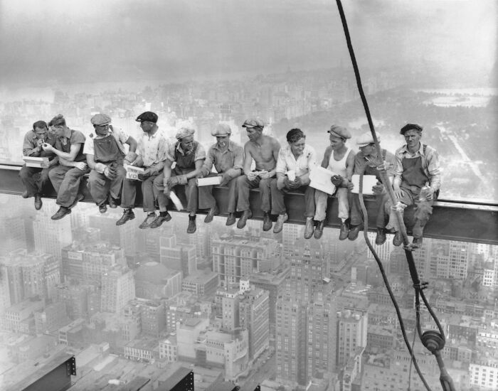 Workers having lunch sitting on a steel beam high above the city, a photo that seems normal until you learn the mysteries behind it.