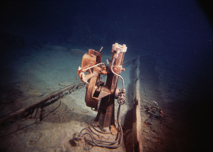 Underwater view of a rusted mechanical device on the Titanic wreck site in a rare historical photo.