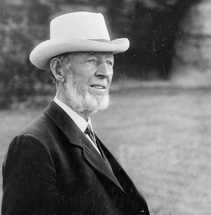 Black and white portrait of an elderly man wearing a white hat and suit, related to famous people animal attacks.