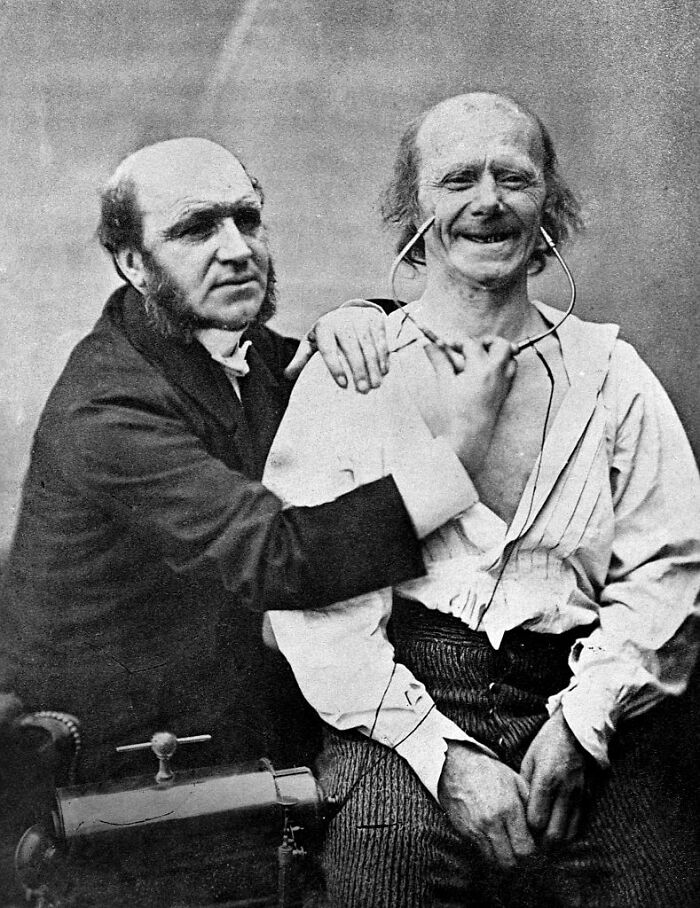 Old-school medical pic showing a doctor examining a smiling patient with a vintage stethoscope in a historical medical setting.