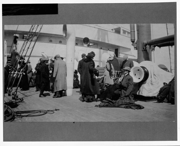 Passengers in period clothing gathered on the deck of the Titanic in a rare historical photo from 1912.