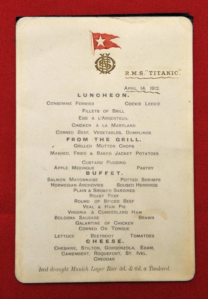 Rare historical Titanic luncheon menu from April 14, 1912 featuring traditional dishes and cheeses on a red background.