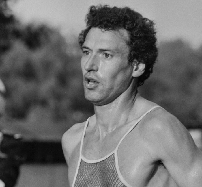 Black and white image of a male athlete sweating during a run, representing famous people involved in animal attacks.