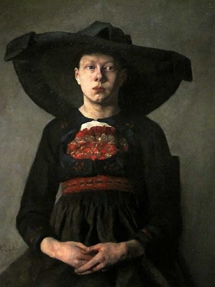 Victorian-era woman in dark clothing and large hat, reflecting bizarre and creepy Victorian facts from history.