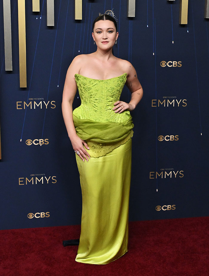 Person wearing a lime green gown posing on the red carpet showcasing best-dressed fashion at the 2025 Emmys event.