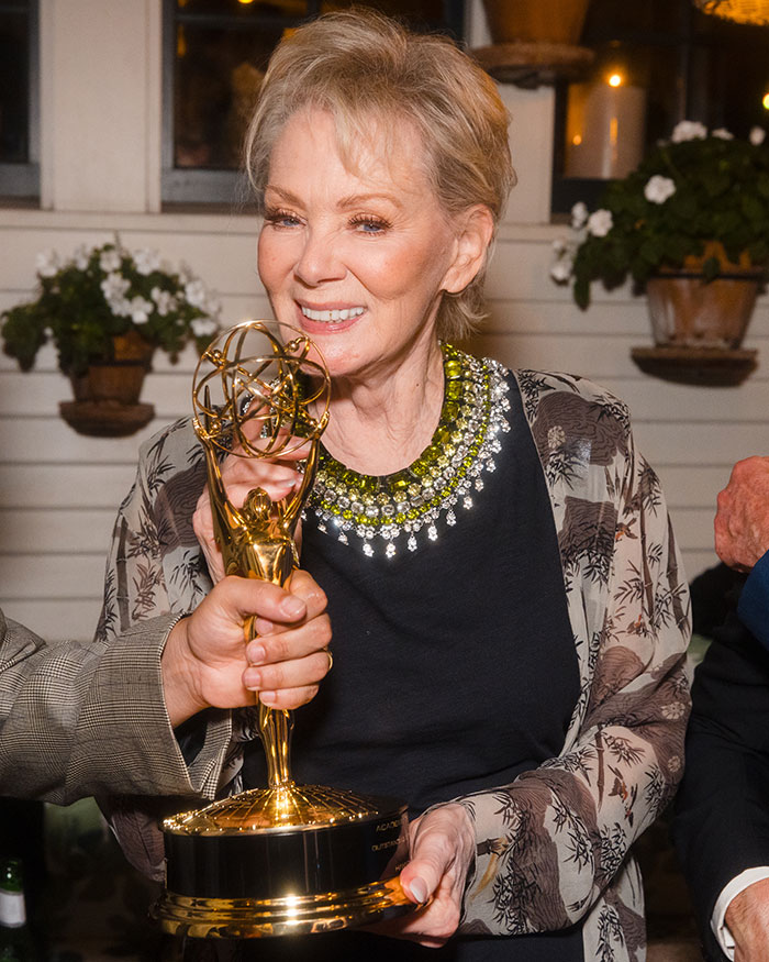 Celebrity wearing a bejeweled outfit holding an Emmy at the after parties of the 2025 Emmys event.