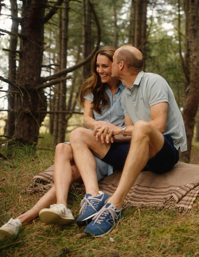 Kate Middleton smiling with a man outdoors, captured in a candid moment amid trees and nature. Kate Middleton smiling with a man outdoors, captured in a candid moment amid trees and nature.