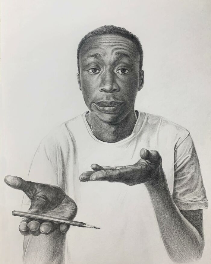 Realistic pencil portrait of a young man holding a pencil, capturing every tiny detail in the detailed shading and expression.