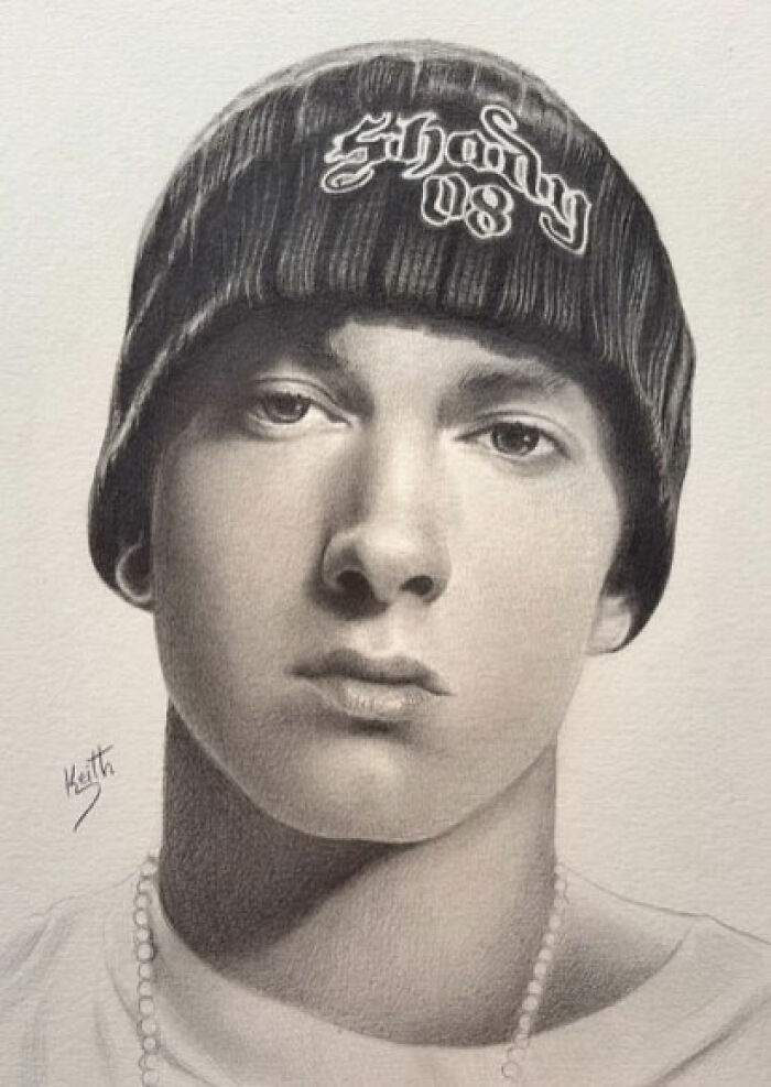 Realistic pencil portrait of a young man wearing a beanie and necklace, capturing every tiny detail with fine shading.