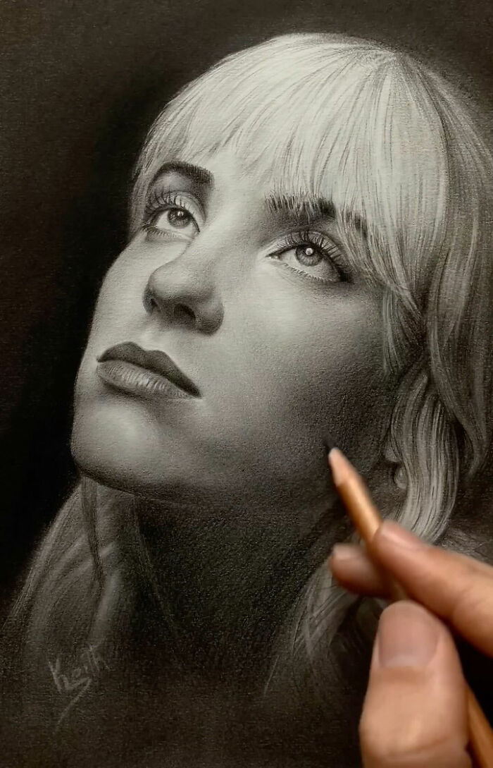 Hand drawing an incredible pencil portrait of a woman, capturing every tiny detail in her delicate facial features.