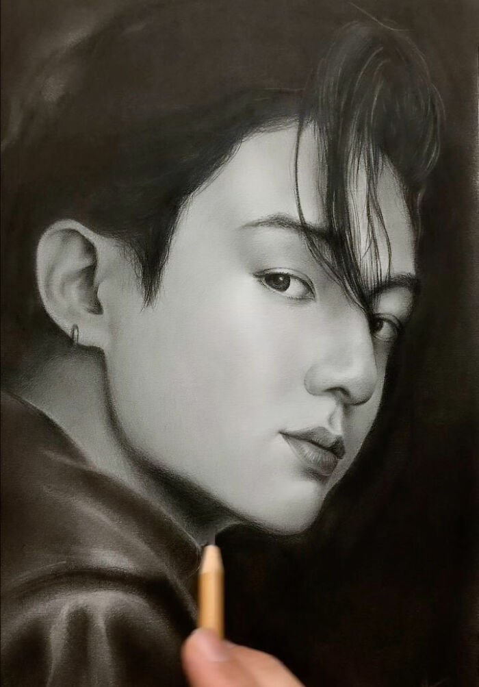 Realistic pencil portrait drawing of a young man with detailed facial features and hair, showcasing incredible pencil portrait skills.