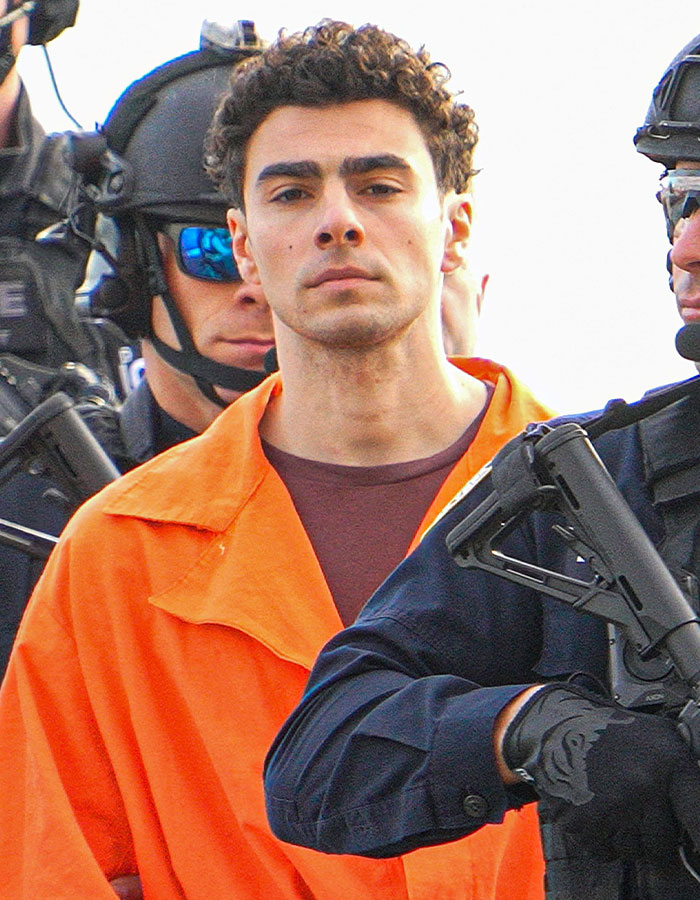 Luigi Mangione in an orange jumpsuit escorted by armed officers in a viral Shein ad related to America&rsquo;s Next Top Model controversy.