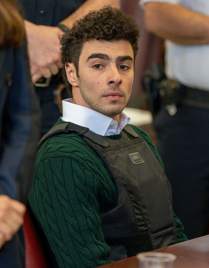 Young man wearing a dark green sweater and protective vest, related to America&rsquo;s Next Top Model Luigi Mangione Shein ad news.